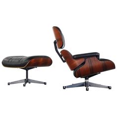 an eames lounge chair and ottoman with black leather upholstered on the back