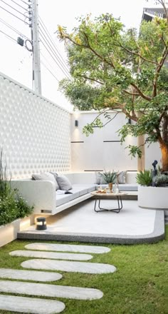 an outdoor living area with grass and stepping stones