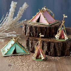 three small tents sitting on top of a wooden table