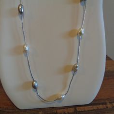 Hello. This Is A Beautiful Freshwater Pearl Station Necklace That I Got Many, Many Years Ago And Never Wore. This Is Not Sterling Silver. It Is 30" Long And Does Not Have A Clasp So It's A Put Over Your Head Necklace. The Freshwater Pearls Are Alternating With Natural Pearl Color And A Dove Gray Color. There Are 16 Pearls In All And Each Pearl Measures About 1/2" In Length And 1/4" In Width. This Varies A Bit Because They Are Natural. They Have Beautiful Luster, And The Silver Chain Is Bright. L Adjustable Silver Single Strand Pearl Necklace, Adjustable Single Strand Silver Pearl Necklace, Silver Metal Chain Necklace For Anniversary, Adjustable Silver Long Pearl Necklace, Adjustable Long Silver Pearl Necklace, Sterling Silver Single Strand Chain Necklace, Adjustable Silver Long Necklace For Formal Occasions, Silver Adjustable Classic Pearl Necklace, Silver Long Necklace With Pearl Chain