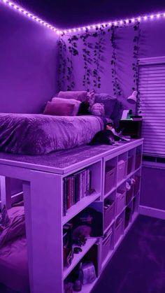 a bedroom with purple lighting and bookshelves in the corner, on top of a bed