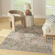 a living room with a couch, chair and rug