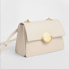 New Classical Beige Chain Crossbody Bag From Charles & Keith. Front Flap With Push-Lock Closure Chain Link Detail Comes With Adjustable Strap (Detachable) Material: Faux Leather Depth (Cm): 11.5 Width (Cm): 22 Height (Cm): 14.5 Come With Original Dust Bag. Elegant Cream Bag With Chain Strap, Elegant Crossbody Shoulder Bag With Gold Chain, Cream Evening Bag With Chain Strap, Elegant Flap Shoulder Bag With Chain Strap, Elegant Shoulder Flap Bag With Chain Strap, Beige Crossbody Evening Bag With Chain Strap, Elegant Crossbody Flap Bag With Chain Strap, Elegant Shoulder Bag With Gold Chain For Daily Use, Elegant Shoulder Bag With Gold Chain For Everyday