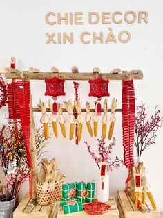 an assortment of decorative items displayed on wooden crates in front of a sign that reads, chie decor xin chao