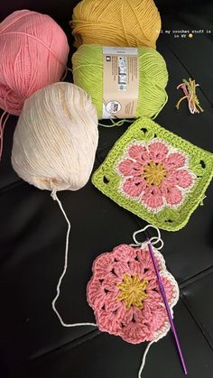 several balls of yarn and crochet on a table