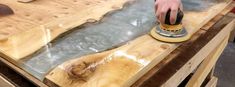 a person sanding wood with a sander on top of it and an iron in the middle