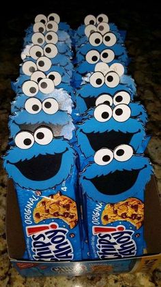 some kind of blue box with eyes and cookies in it's wrappers on a table