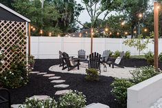 an outdoor patio with chairs and lights