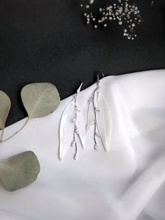 White leaves earrings for bride Handmade White Leaf-shaped Earrings, White Leaf-shaped Earrings With Ear Wire, Silver Leaf-shaped Earrings For Wedding, Handmade Leaf-shaped Earrings For Weddings, Delicate Silver Crystal Earrings With Ear Wire, Nature-inspired Dangle Earrings For Weddings, Handmade Leaf-shaped Wedding Earrings, Leaf-shaped Wedding Jewelry With Matching Earrings, Handmade Clear Earrings For Wedding