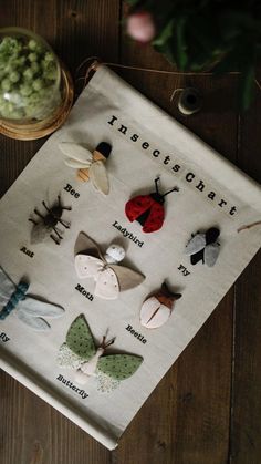 an insect themed tea towel on a wooden table