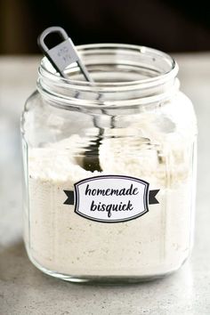 a glass jar filled with homemade biscuits on top of a table