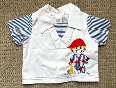 "Adorable and playful 60s / 70s collared tee / blouse with a cute embroidered baseball player. Comfy boxy fit. Rear button closure.  Excellent vintage condition  No size tag - I estimate 9-12 mos but please check measurements: 12\" pit to pit 11\" shoulder to hem Follow us on Instagram! @rainbowkidsvintage" Vintage White Top For School, Cute Collared Tops For Playtime, Cute Collared Tops For Play, Retro White Shirt For School, Retro White School Shirt, Vintage Tops For Playtime In Spring, Vintage Tops For School In Spring, Vintage Style Tops For Playtime In Spring, Vintage Cotton Tops For Playtime