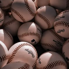 a pile of baseballs sitting next to each other