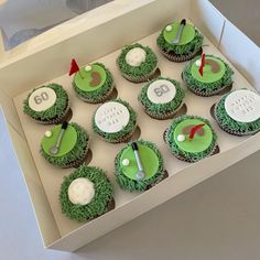 the cupcakes are decorated with green frosting and golf related decorations on them