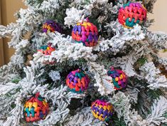 a christmas tree decorated with multicolored ornament balls