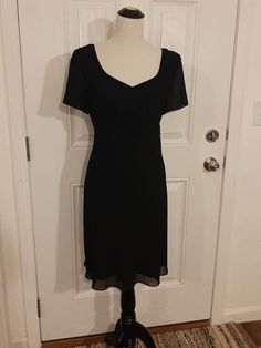 "Vintage Womens Special Occasion Black Lined Spring/Summer Dress Size M-L Excellent Vintage Condition.  Very Clean, No Tears Or Snags.  Shows Little Wear Made By Blushe Spiegel, Marked Size 12 Polyester/Acetate Black Sheer Outer Layer Black Soft Taffeta Lining Sweetheart Neckline Empire Waist Short Semi Sheer Sleeves 16\" Black Nylon Back Hidden Zipper Fabric Hangs Beatifully Knee Length Or Above/Below Depending On Height Bust 40\" Waist 34\" Hips 43\" Sleeves 8\" Length 36\" Weight 14 Oz" Classic Fitted V-neck Vintage Dress, Black Vintage Summer Dress For Formal Occasions, Black Vintage Dress For Summer Formal, Classic Vintage Evening Dress For Summer, Black Vintage Dress For Formal Summer Events, Black Vintage Short Sleeve Dress For Summer, Black Short Sleeve Vintage Dress For Summer, Formal Summer Midi Dress With Empire Waist, Classic Evening Mini Dress For Summer