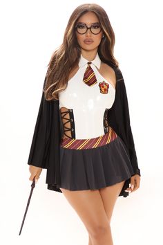 a woman dressed in a costume and holding a wand is posing for the camera with her hands on her hips