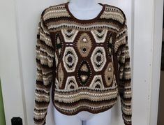 Groovy multicolor crochet sweater in beige, tan, black, brown and white from the 1990s. Perfect for your boho or hippie style. Cotton/ramie blend means it is not itchy like wool - hand washable. Tag size medium - Laying flat UNstretched it measures 18" across (36 inches total); 19 inches long. In good condition - Clean (freshly laundered), no stains, no holes, shows only a little wear.  Measured flat so fit may vary - be sure to measure a similar garment that fits you for comparison. For more vintage clothing for women and men from the 1960s, 1970s, 1980s, & 1990s, visit  https://www.etsy.com/shop/VirgieMae Crochet Sweater 70s, Retro Brown Knit Sweater, 70s Wool Sweater, Handmade Multicolor Vintage Sweater, Vintage Brown Striped Sweater, Hippie Crochet, Boho Sweater, Mode Hippie, Pullover Sweater Women