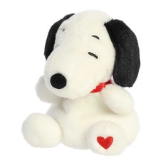 a stuffed dog with a heart on it's collar and nose is sitting down