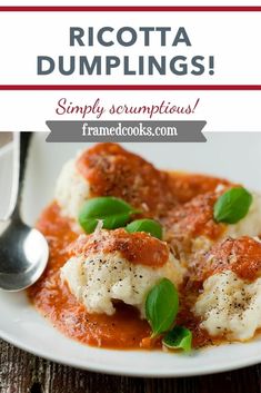 a white plate topped with ravioli dumplings covered in marinara sauce and basil