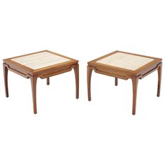 a pair of tables with wooden legs and square tops on each side, one is made out of wood