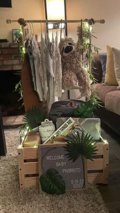 a teddy bear sitting on top of a wooden crate filled with clothes and other items