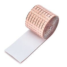 a roll of woven tape on top of a piece of paper with an adhesivee