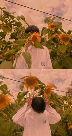 a person standing in front of sunflowers with their hands up to their face