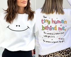 Dear Tiny Humans Behind Me, Teacher Sweatshirt, Inspirational Teacher Gift, Teacher Appreciation,Aesthetic Teacher Sweatshirt,Back To School Thank you so much for choosing us! How To Order 1️⃣ Please review all the information provided before placing an order. 2️⃣ Select the sweatshirt type and size using the drop down menu. 3️⃣ Select the color of the shirt using the following drop down menu. 4️⃣ Once all your desired items are in your cart you may complete your order by entering your payment method, desired shipping address and click submit. Shipping Time Shipping will take 1-3 business days Inspirational White Top For Gifts, Inspirational White Top As Gift, Inspirational Crew Neck Top As Gift, Inspirational Crew Neck Top With Custom Print, Inspirational White Tops With Custom Print, Inspirational White Top With Custom Print, Inspirational Custom Print White Top, Inspirational Long Sleeve White T-shirt, White Crew Neck Shirt For Teacher Appreciation