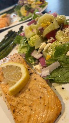 salmon, salad and asparagus on a plate at a restaurant in the united states