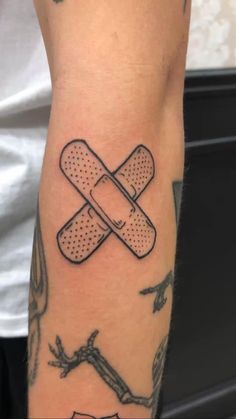 a man with a tattoo on his arm that has a band aids attached to it