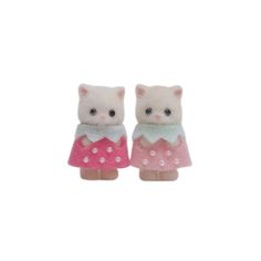 two small white cats wearing pink and green dresses with polka dots on the bottom, standing next to each other