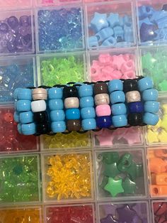 many different colored beads in plastic containers