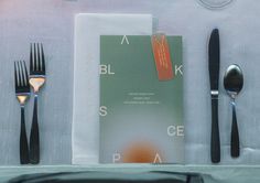 forks, knives and spoons are laid out on a table