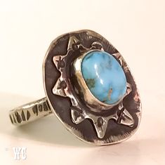 Lots of texture and contrast in this fun Sterling Silver ring with a serene Turquoise stone from the Tomahawk Mine. This ring has TONS of personality with a starburst face and punched dot detail. Band has a notched texture. Sterling Silver has been oxidized + blackened to enhance all the textured action going on. Size 9.75 - Refer to photo on ring mandrel Band measures approximately 1/8" Face of ring measures approximately 7/8" wide x 1" I handcraft one-of-a-kind pieces using traditional silvers Unique Stamped Turquoise Ring, Unique Adjustable Stamped Turquoise Ring, Artisan Stamped Turquoise Ring, Unique Hand Forged Turquoise Ring, Ring Mandrel, Silver Turquoise Ring, Mega Star, Silver Turquoise, Turquoise Sterling Silver