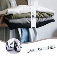 a person holding some folded clothes with the word full on it