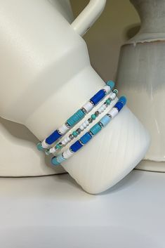 A beachy collection of blue and turquoise beaded bracelets hand crafted to add personal style to your Stanley cup.  🌟 Great for gift giving, holidays, sports, parties, and everyday charm. 🌟 Set includes 3 bracelets designed to fit the 40oz Stanley Quencher with a silicone boot in place.  🌟Variation https://tinebirddesigns.etsy.com/listing/1738326186 Tips & Care: - Will also fit the 20oz and 30oz Stanley cups with a silicone boot (not included) - Remove bracelets prior to washing tumbler. Not Adjustable Blue Beaded Bracelets For Beach, Blue Friendship Bracelets With Colorful Beads For Vacation, Blue Adjustable Bracelet For Beach Season, Adjustable Blue Bracelet For Beach Season, Turquoise Heishi Beads Bracelets For Summer, Blue Colorful Beaded Friendship Bracelets For Beach, Blue Friendship Bracelets For Beach Season Gift, Blue Friendship Bracelets With Colorful Beads For Beach, Beach Blue Friendship Bracelets With Colorful Beads