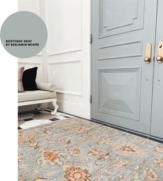 a room with a door and rug on the floor in front of it that is painted gray