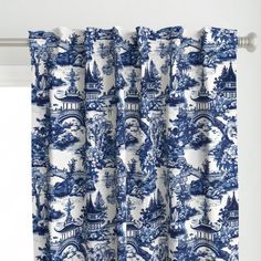 blue and white toiler print curtains hanging on a curtain rod in front of a window