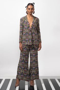 Black blazer with multi colored wild orchids vines and floral patterns. Comes with coordinating flared pant. - Aza Fashions Multicolor Long Sleeve Suits For Spring, Elegant Fitted Floral Print Pants, Floral Print Sets For Workwear In Fall, Fitted Multicolor Pantsuit For Workwear, Spring Fitted Printed Suits, Elegant Fitted Multicolor Pants, Elegant Fitted Printed Suits, Fitted Multicolor Suits For Spring, Fitted Bohemian Floral Print Pants