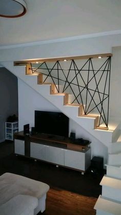 a living room with white walls and stairs