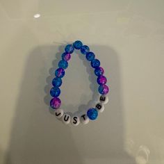 Handmade Beaded Bracelet That Says Just Be Casual Purple Bracelets With Colorful Beads, Casual Purple Friendship Bracelets With Letter Beads, Casual Purple Friendship Bracelet With Letter Beads, Trendy Blue Beaded Bracelet With Large Beads, Casual Purple Friendship Bracelets With Round Beads, Casual Purple Round Beads Friendship Bracelets, Casual Purple Beaded Bracelets, Trendy Hand-strung Purple Bracelets, Casual Purple Beaded Bracelets With 8mm Beads