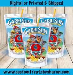 three bags of captain sun cereal sitting on top of a wooden table next to each other