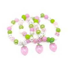 These adorable bracelets are the perfect favor for your little one's strawberry party! Each bracelet features an enameled, gold plated charm, resin rhinestone beads and an assortment of 10mm acrylic beads in red, dark green, pink and bright green strung with durable stretch floss cord. Your bracelets will arrive individually packaged in color coordinating organza bags. If you would like your bracelets made in a different color combination, just let me know! I can make your bracelets to match you Strawberry Party Favors, Strawberry Themed Party, Bracelets Red, Diy Kandi, Strawberry Charm, Strawberry Party, Birthday Bracelet, Cardboard Jewelry Boxes, Small Jewelry Box