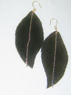 Women's Black Leather Fringe Feather Earrings/Boutique Jewelry Nice pair of genuine suede leather feather fringed earrings~ The curved feather is fringed though hard to see in the photo's. This pair is large size leaf at 3 x 1.6 inches.  A silver tone chain hangs in the center with small curved fish hooks for earlobe. They look the same on both sides except no chain on back. Great little gift for the boho chic lady, sister, aunt, mother, best friend or wife. Handmade in my beading shop...USA.    You receive the item pictured here as I do not make but one of each. Fringed Earrings, Fish Hooks, Leather Fringe, Feather Earrings, Fringe Earrings, Boutique Jewelry, Little Gifts, Suede Leather, 6 Inches