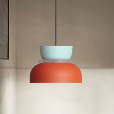 an orange and blue bowl hanging from a light fixture