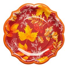 a red plate with yellow leaves and berries on the rim, against a white background