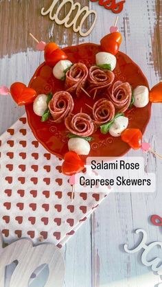 a red plate topped with lollipops on top of a white wooden table