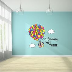 an empty room with a blue wall and colorful balloons on the wall that says adventure is out there