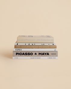 three books stacked on top of each other in front of a beige background with the words picaso and mayoa